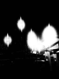 Illuminated street in city at night