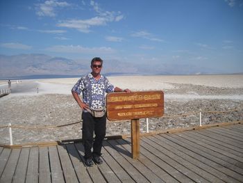 Full length portrait of young man standing against sea against sky