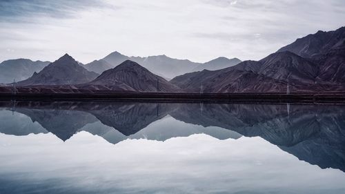 Reflection of mountains in lake against sky