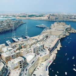 High angle view of buildings by sea against sky