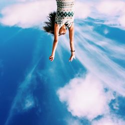 Low angle view of a woman jumping