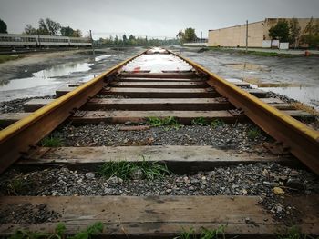 Railroad tracks by trees against sky