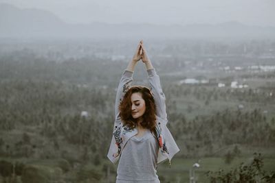 Portrait of woman standing in foggy weather