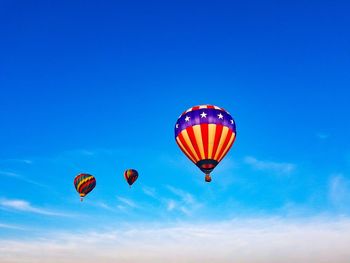 Low angle view of hot air balloon against blue sky