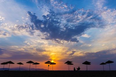 Scenic view of beach against sky during sunset