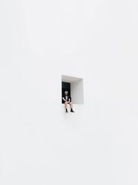 High angle view of man and woman standing against white background