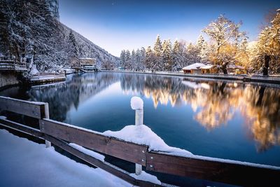 Reflection of trees in lake during winter