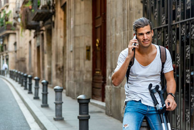 Portrait of young man standing in city