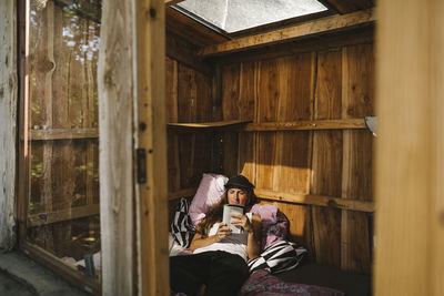 Woman in hut reading book