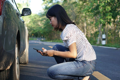 Full length of man using mobile phone