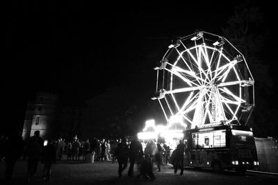 People at amusement park ride at night