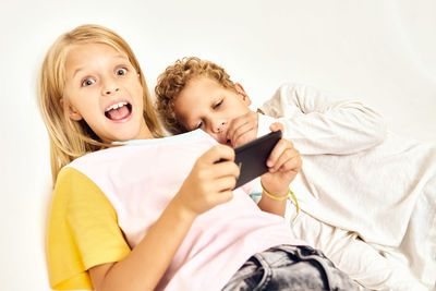 Portrait of young woman using mobile phone at home