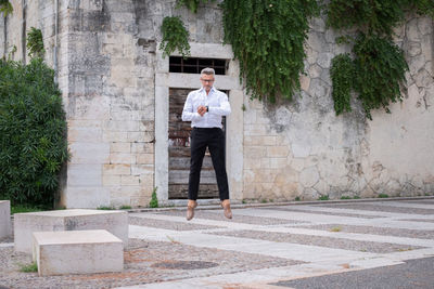 Full length of man standing on footpath