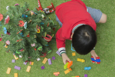 High angle view of girl playing on grass