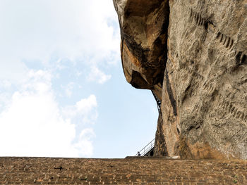 Low angle view of rock formation against sky