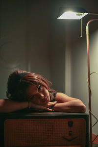 Vintage style girl laying on old radio