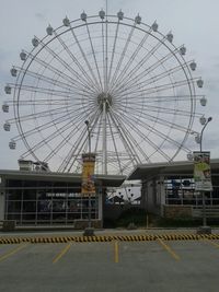 Low angle view of ferris wheel against sky