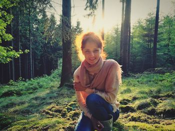 Portrait of smiling young woman in forest