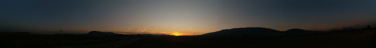 Scenic view of silhouette mountains against sky during sunset