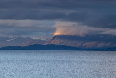 Scenic view of mountains against cloudy sky