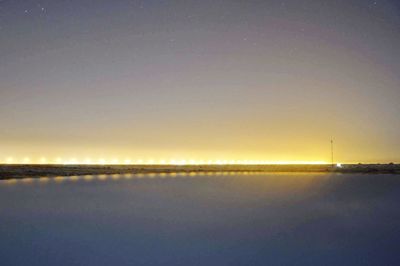 Scenic view of sea against clear sky at night