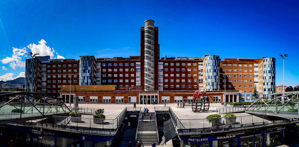 Modern buildings against blue sky in city