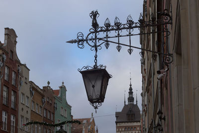 Low angle view of street light and buildings against sky