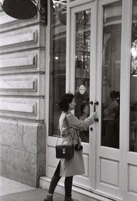 Woman standing against door